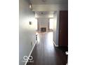Hallway view of fireplace and hardwood floors at 7659 Misty Meadow Dr, Indianapolis, IN 46217