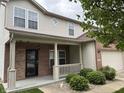 Charming two-story home with a brick facade, covered porch, and well-maintained landscaping at 8048 Garden Ridge Rd, Indianapolis, IN 46237