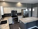 Stylish kitchen with white cabinetry, granite countertops, stainless steel appliances, and center island with bar seating at 8048 Garden Ridge Rd, Indianapolis, IN 46237