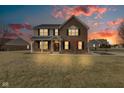 Stunning two-story brick home with a welcoming front porch and beautiful sunset view at 8218 Elsen Ridge, Avon, IN 46123