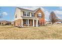 Attractive two-story home featuring brick and siding, a covered porch, and a spacious front yard at 8218 Elsen Ridge, Avon, IN 46123