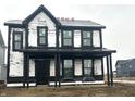Two-story house features black trim, Tyvek house wrap, and a covered porch, showcasing its modern design and construction phase at 9345 Anthem Ave, Plainfield, IN 46168