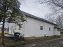 Side view of a two-story home with white siding and visible roofline at 1031 Nichol Ave, Anderson, IN 46016