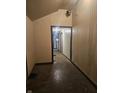 Narrow hallway showcasing dated paneling, trim, and weathered flooring at 1031 Nichol Ave, Anderson, IN 46016