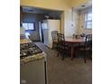 Kitchen with dated appliances, tile floor, and an eat-in dining table at 1031 Nichol Ave, Anderson, IN 46016