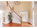 Grand foyer with hardwood floors, elegant staircase, chandelier, and bright natural light at 11478 Muirfield Trce, Fishers, IN 46037