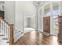 Inviting foyer with hardwood floors, large windows, and a view into the dining area at 13701 Cheswick Blvd, Carmel, IN 46032