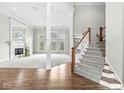 Bright living room showcasing a fireplace, carpet, and an abundance of natural light at 13701 Cheswick Blvd, Carmel, IN 46032
