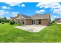 Spacious backyard featuring a well-maintained lawn and concrete patio, perfect for outdoor entertaining at 1393 N Salem Ct, Greenfield, IN 46140