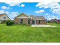 Spacious backyard featuring a well-maintained lawn and concrete patio, ideal for outdoor activities at 1393 N Salem Ct, Greenfield, IN 46140