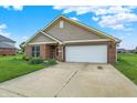 Charming brick home with a well-manicured lawn, inviting entrance, and a two-car garage at 1393 N Salem Ct, Greenfield, IN 46140