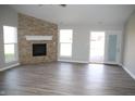Inviting living room features a stacked stone fireplace, modern flooring, and ample natural light at 1393 N Salem Ct, Greenfield, IN 46140