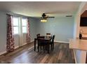 Dining room with wood floors, a ceiling fan, and a table with four chairs at 1435 E New Rd, Greenfield, IN 46140