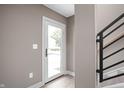 Bright entryway featuring a white door with glass and a modern staircase with black railings at 1517 E New York St, Indianapolis, IN 46201