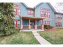 Charming front porch with stone pillars, wood railing, and front door at 1623 N College Ave # 2, Indianapolis, IN 46202