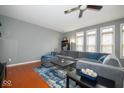 Spacious living room with hardwood floors, a ceiling fan, and plenty of natural light at 1623 N College Ave # 2, Indianapolis, IN 46202