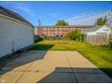 An expansive backyard features a concrete patio area, perfect for entertaining or enjoying outdoor activities in a private setting at 2011 N Hollywood Ave, Muncie, IN 47304