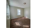 A bright bedroom with neutral walls and two windows, offering a tranquil space with natural light and comfortable carpeting at 2011 N Hollywood Ave, Muncie, IN 47304
