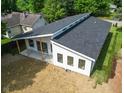 Rear view of modern home featuring a patio, large windows, and sleek roofline at 2689 Pearl St, Columbus, IN 47201