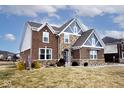 Attractive two-story house with brick and stone facade, complemented by manicured landscaping and a green lawn at 3258 Cherokee Cir, Bargersville, IN 46106