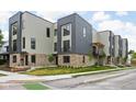Modern townhome exteriors featuring brick accents, gray and tan siding, and manicured lawns along the sidewalk at 326 N Summit St, Indianapolis, IN 46201
