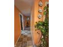 Hallway with decorative plates and lush green plant creating a warm and inviting transition space at 3624 Columbus Ave, Anderson, IN 46013