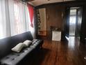 Living room area featuring hardwood floors, a couch, and stylish decor, creating a welcoming atmosphere at 3624 Columbus Ave, Anderson, IN 46013
