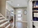 Foyer with tiled floors, wooden stairs and white door with windows at 3659 Watson Rd, Indianapolis, IN 46205