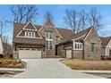 A beautiful two-story brick home with a three-car garage and a well manicured yard at 4135 Hamilton Run, Zionsville, IN 46077