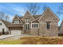 Attractive brick two-story home with a spacious three-car garage, awaiting a new lawn at 4135 Hamilton Run, Zionsville, IN 46077