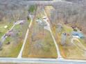 Aerial view of the property with property lines outlined in red in a wooded setting at 6602 S 400 W, Columbus, IN 47201