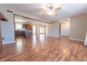 Open-concept living room with wood-look floors and a view of the kitchen at 6602 S 400 W, Columbus, IN 47201