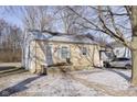 Cozy one-story home featuring a quaint front porch and a partially snow-covered yard at 715 S Ribble Ave, Muncie, IN 47302