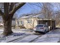 Inviting single-story home with an attached carport and a snow-dusted driveway at 715 S Ribble Ave, Muncie, IN 47302