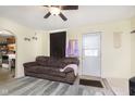 Comfortable living room featuring a ceiling fan, cozy sofa, and neutral decor at 715 S Ribble Ave, Muncie, IN 47302