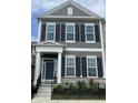 Charming two-story townhome featuring a dark-blue front door, large windows, black shutters, and a well-maintained lawn at 848 Kinzer Ave, Carmel, IN 46032