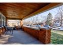 Relaxing covered front porch with brick pillars and wood ceiling at 916 N Audubon Rd, Indianapolis, IN 46219
