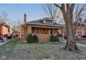 Charming brick home featuring a classic craftsman style and mature trees at 929 N Audubon Rd, Indianapolis, IN 46219