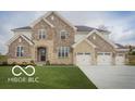 Elegant two-story home with stone and brick, featuring a spacious three-car garage at 9658 Farragut, Indianapolis, IN 46256