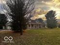 Well-maintained property featuring a spacious front yard and charming exterior at 1039 W 550 S, Trafalgar, IN 46181