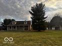 Traditional home with a large front lawn and mature trees at 1039 W 550 S, Trafalgar, IN 46181