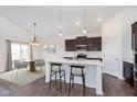 Stylish kitchen with dark cabinetry, stainless steel appliances, an island and breakfast nook at 1438 Willow Tree Ln, Sheridan, IN 46069