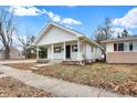 Quaint home showcasing a covered front porch and tidy landscaping at 1533 Castle Ave, Indianapolis, IN 46227