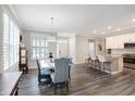 This dining room features beautiful wood floors, lots of light, and an open floor plan at 17330 Graley Pl, Westfield, IN 46074