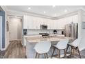 Bright and airy kitchen featuring a large island with seating and modern stainless steel appliances at 17330 Graley Pl, Westfield, IN 46074