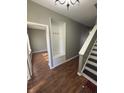 Welcoming entryway with hardwood floors, coat rack, and staircase leading to the upper level at 1881 Harvest Meadow Dr, Greenwood, IN 46143