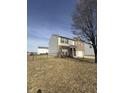 This house features a well-maintained lawn and a chain-linked fence surrounding the property for added privacy and security at 1881 Harvest Meadow Dr, Greenwood, IN 46143
