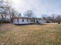 Spacious backyard showcasing the home's pristine exterior, and a detached garage with ample space at 2219 W 59Th St, Indianapolis, IN 46228