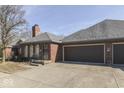Charming brick home featuring a three-car garage and a well-manicured front yard and nice curb appeal at 223 Andrews Boulevard East Dr, Plainfield, IN 46168