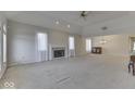 Spacious living room featuring a fireplace, neutral carpet, lots of windows, and ample natural light at 223 Andrews Boulevard East Dr, Plainfield, IN 46168